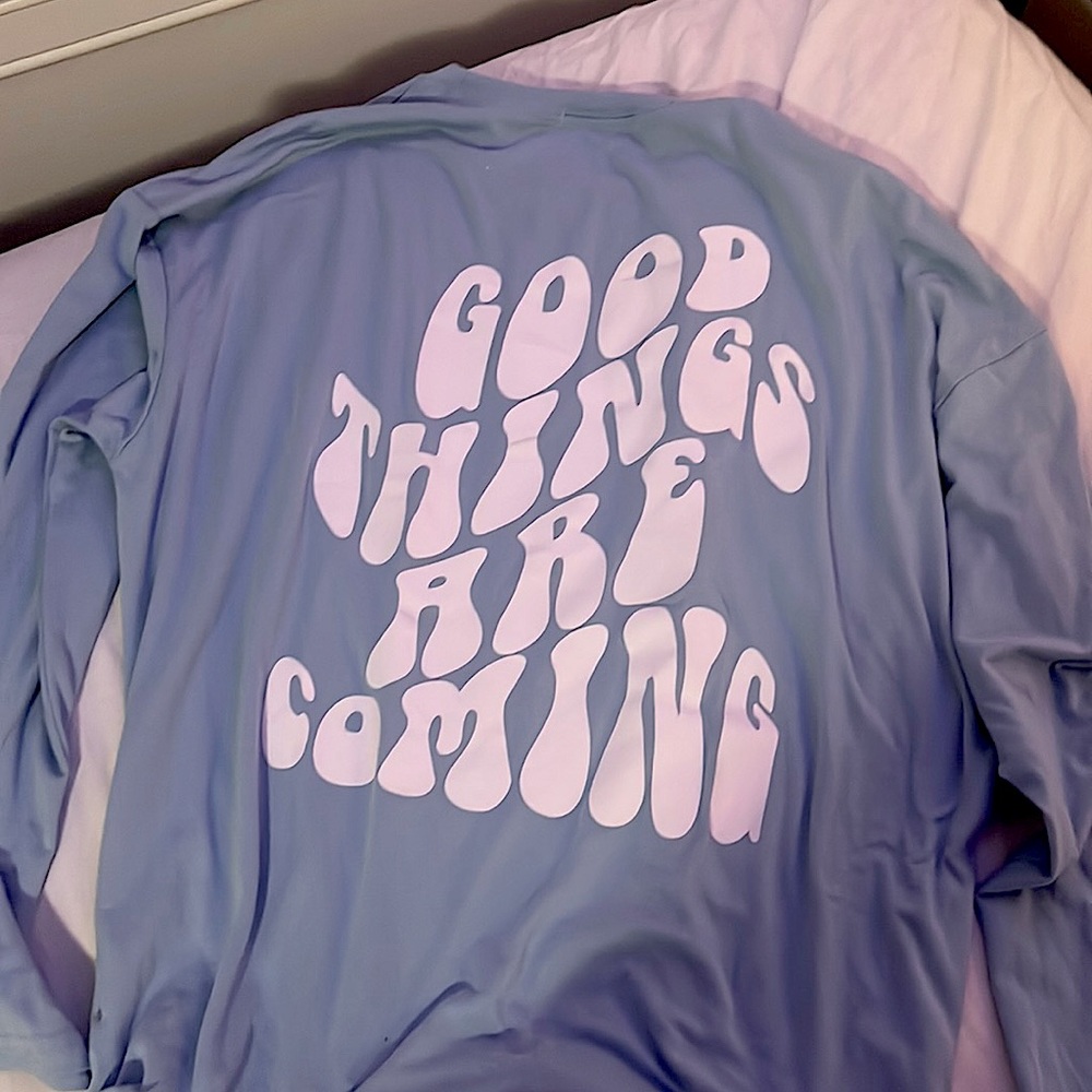 Good things are coming on the back of a blue long sleeve